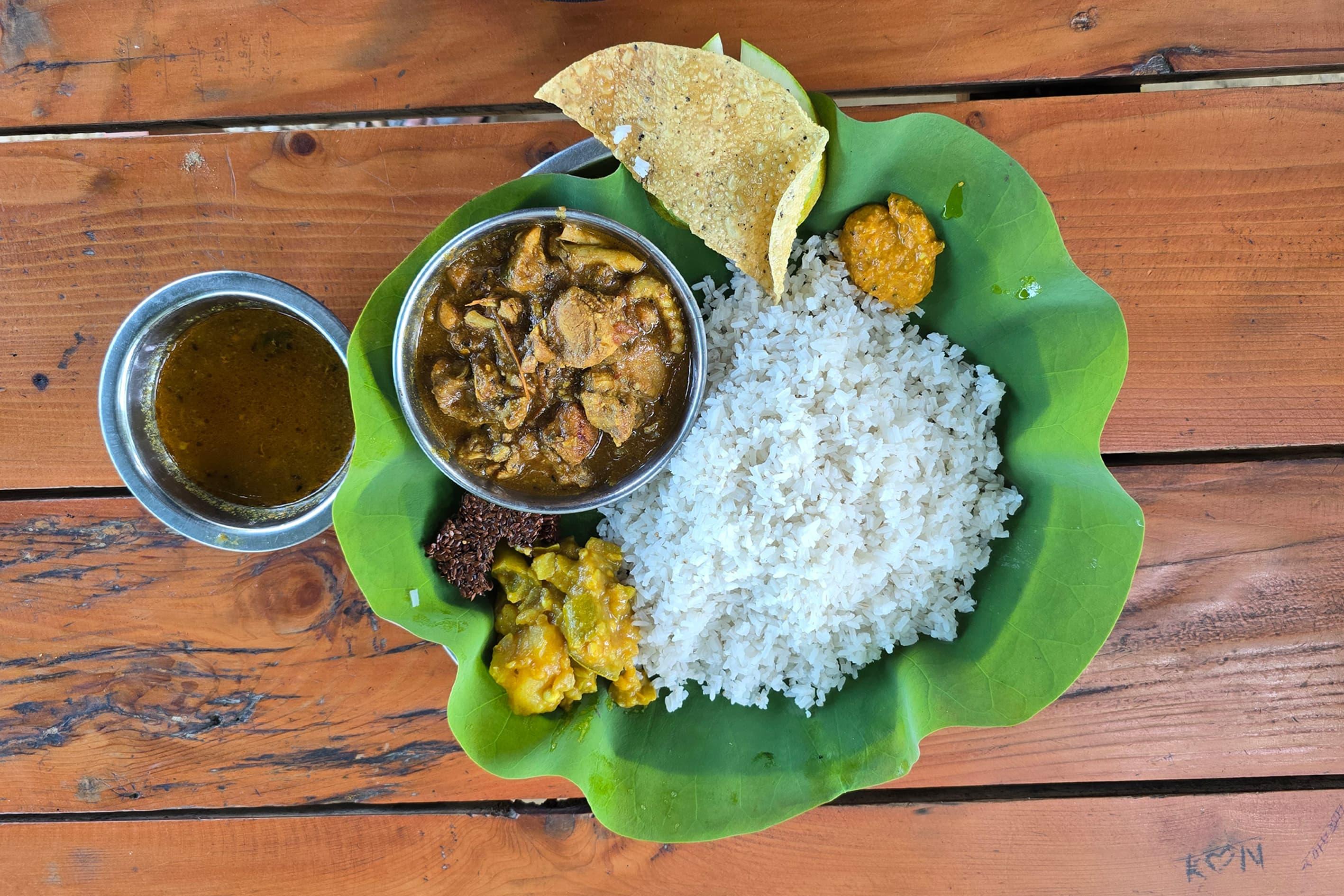 Traditional Nepali thali served on banana leaf