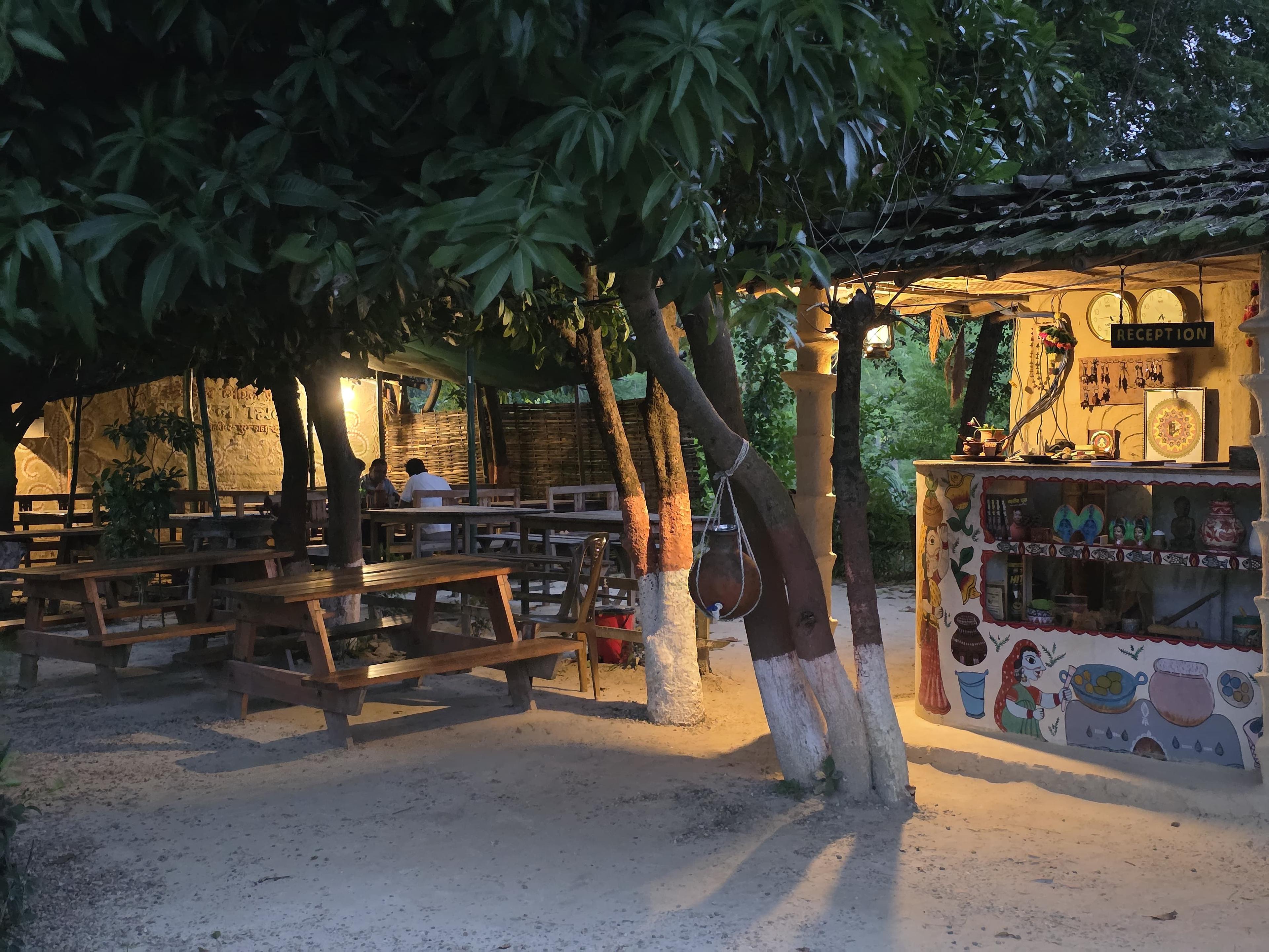 Reception area with Mithila-painted desk under trees